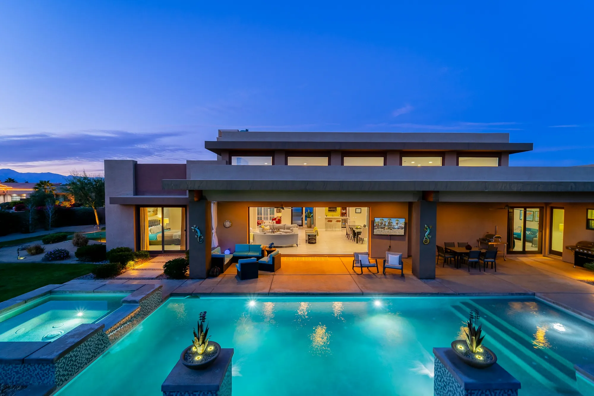 A villa with a pool at dusk